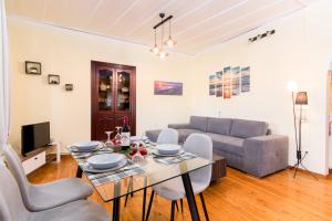 a living room with a table and a couch at Tenedos old town in Corfu Town