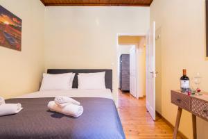 a bedroom with a bed with two towels on it at Tenedos old town in Corfu Town