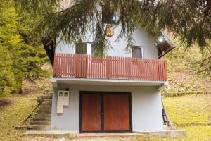 a small house with a balcony on top of it at Villa Katharina in Kakanj