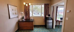 a room with a dresser and a window and a dresser with a dress at Butterfly Grove Inn in Pacific Grove