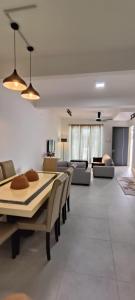 a living room with a table and chairs and a couch at Sierra Hill Homestay in Kampong Lepau