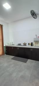 a kitchen with a counter top and a stove at Sierra Hill Homestay in Kampong Lepau +11 photos