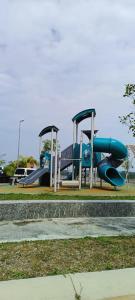 a playground with two slides in a park at Sierra Hill Homestay 