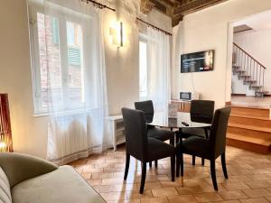 a dining room with a table and chairs at GH Paradiso - Apartments in Siena