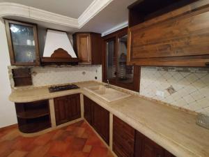 a kitchen with a sink and a counter top at SanVitoTour- Residence Il Baglio in San Vito lo Capo
