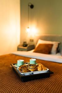 a tray of food on a table with a bed at Under The Pine in Engure