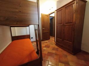 a bedroom with a bunk bed and a closet at SanVitoTour- Residence Il Baglio in San Vito lo Capo