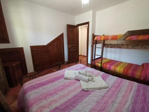 a bedroom with two bunk beds with towels on a bed at SanVitoTour- Residence Il Baglio in San Vito lo Capo