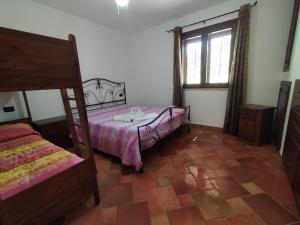 a bedroom with a bed and a window at SanVitoTour- Residence Il Baglio in San Vito lo Capo