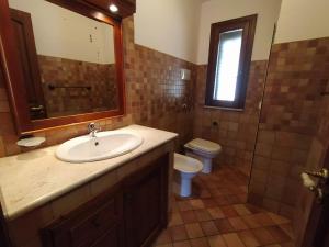 a bathroom with a sink and a toilet at SanVitoTour- Residence Il Baglio in San Vito lo Capo