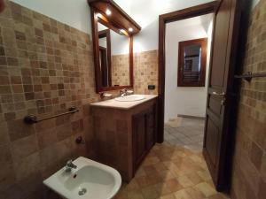 a bathroom with a sink and a mirror at SanVitoTour- Residence Il Baglio in San Vito lo Capo