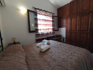 a bedroom with a bed with a stuffed animal on it at SanVitoTour- Residence Il Baglio in San Vito lo Capo