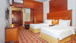 Postel nebo postele na pokoji v ubytování Hotel Savoy Homann
