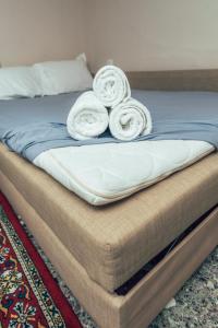 a bed with two rolled towels on top of it at Eptalofos Studio loft in Thessaloniki