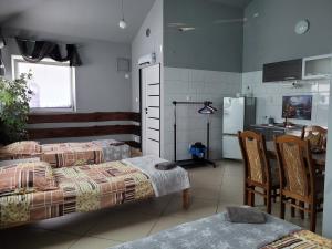 a kitchen with two beds and a table and a refrigerator at Sebar in Gorzyce