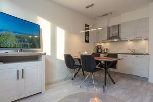 a kitchen and dining room with a table and chairs at Fewo Schröder - Tolle in Norderney +38 photos