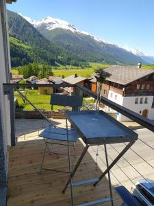 a table and chair on a balcony with a mountain at Haus Rovina in Münster