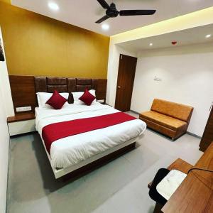 a bedroom with a large bed and a couch at HOTEL EAGLE INN, NARODA in Ahmedabad