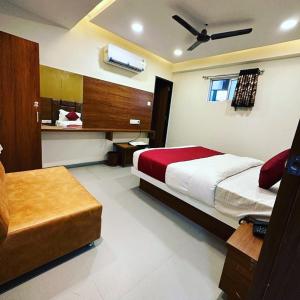 a hotel room with a bed and a couch at HOTEL EAGLE INN, NARODA in Ahmedabad
