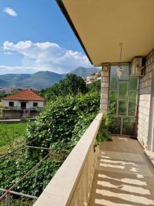 a balcony with a view of a vineyard at Apartman Milija in Trebinje