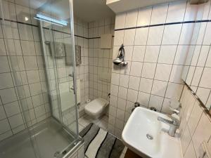 a bathroom with a shower and a sink and a toilet at Apartment Häuserstraße 15 in Northeim +19 photos
