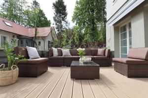 a patio with couches and a table on a house at Willa Szwarc by Elite Apartments in Sopot