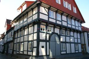 un bâtiment noir et blanc avec un toit rouge dans l'établissement Apartment Häuserstraße 15, à Northeim