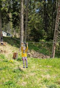 a young child is playing with a zip line at Complex Transalpina Lac in Voineasa