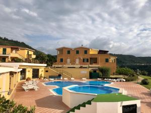 a resort with a swimming pool and a building at A View 2 Sea in Parghelia