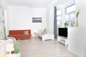 uma sala de estar branca com um sofá e uma televisão em CO03-HI Apartment in Coburg em Coburgo