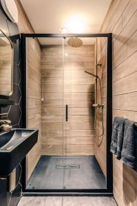 a bathroom with a shower with a glass door at Sweeney Aviemore One in Aviemore +42 photos