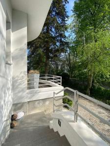 a porch of a house with a bench and trees at Casa Cuniolo Guest House in Tortona