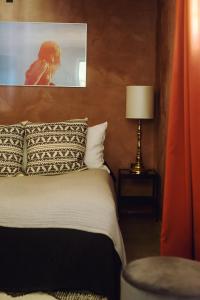 1 dormitorio con 1 cama con una foto en la pared en The Norrmans Farmhouse Boutique Hotel, en Klippinge