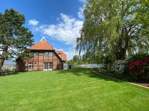 a large brick house with a large yard at Landhaus Lotten in Winsen