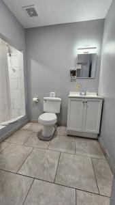 a bathroom with a toilet and a sink and a mirror at Travelers Inn in Flagstaff +35 photos