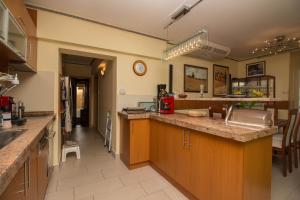 a large kitchen with a counter and a counter top at 299 - Teljes panorámás közvetlen balatonparti exkluzív apartman in Balatonőszöd +2 photos
