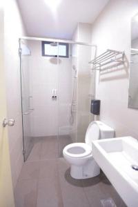 a bathroom with a shower and a toilet and a sink at Cozy Haven Atlantis with Large Swimming Pool in Melaka