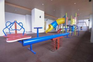 a childrens play area with a colorful playground at Cozy Haven Atlantis with Large Swimming Pool in Melaka