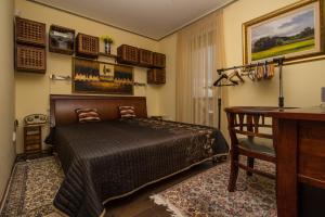 a bedroom with a bed and a desk in it at 299 - Teljes panorámás közvetlen balatonparti exkluzív apartman in Balatonőszöd
