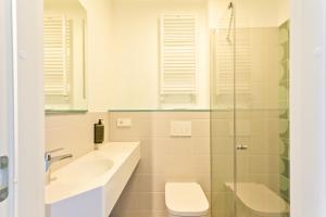 a bathroom with a sink and a toilet and a shower at IBIS Styles Kaunas Centre in Kaunas