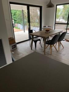 a dining room with a wooden table and chairs at Killara Kottage in Tumut