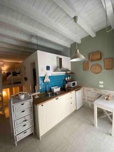 a kitchen with a sink and a table in it at centro storico in Giovinazzo