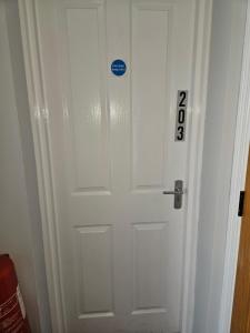 a white door with a sign on it at Laverty's - The Black Bull Inn in Randalstown