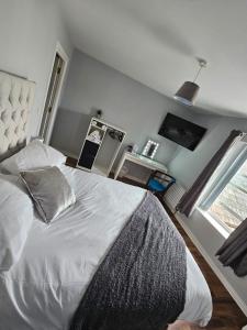 a bedroom with a bed with a pillow and a window at Laverty's - The Black Bull Inn in Randalstown