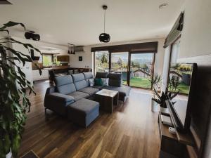 a living room with a couch and a table at Apartamenty Blisko Słońca in Nowy Targ