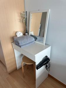 a white desk with a mirror and a black at Hongdae Guesthouse 1min from Hongik Uni station Exit #1 in Seoul