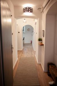 a hallway of a home with a door and a rug at Apartman Amelie in Sopron