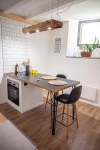 a kitchen with a table and chairs in a room at Apartman Amelie in Sopron