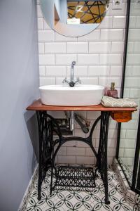 a bathroom with a sink on a table with a mirror at Apartman Amelie in Sopron