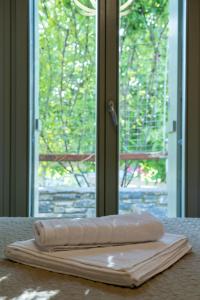 two towels sitting on a table in front of a window at Villa Jasmine in Platanidia